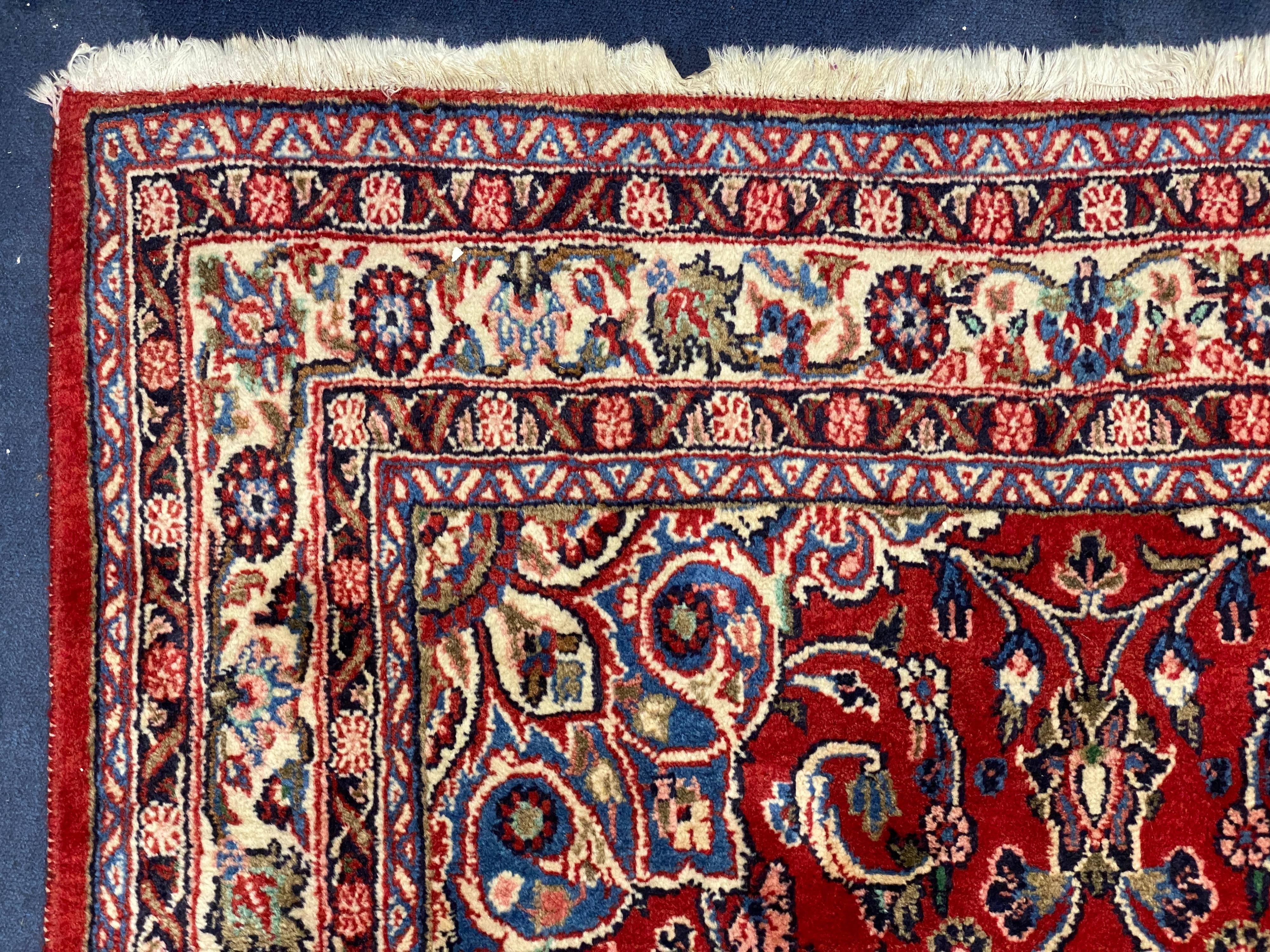 A Northwest Persian red ground rug, 240 cm x 136 cm